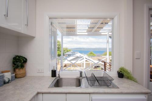 a kitchen with a sink and a large window at Harbour Rest in Albany