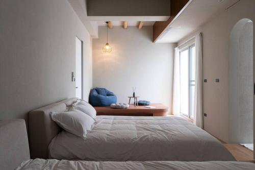 a bedroom with a bed and a large window at Plant House in Chiayi City