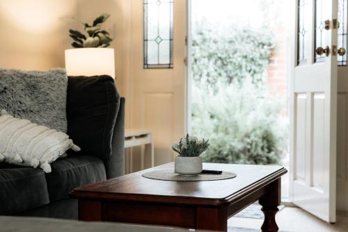 a living room with a couch and a coffee table at Coastal Garden Villa in Albany