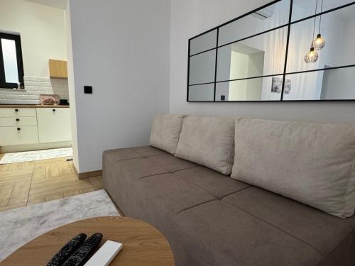 een woonkamer met een bank en een tafel bij Apartman A in the heart of Ferhadija - Parking available in Sarajevo