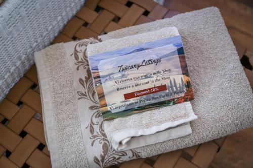 a pile of towels sitting on top of a chair at MontepulcianoLettings in Montepulciano