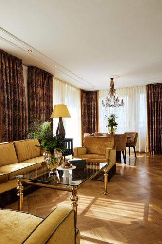 a living room with a couch and a table at Parkhotel Gütersloh in Gütersloh
