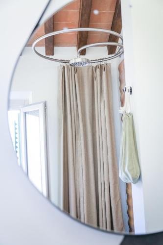 a mirror reflection of a curtain in a room at MontepulcianoLettings in Montepulciano
