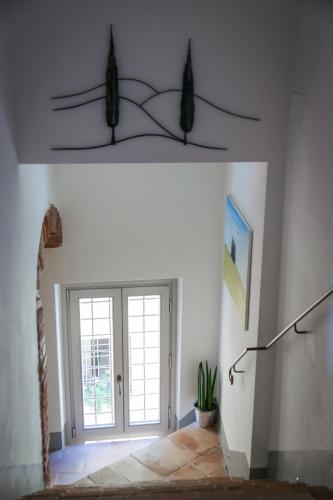 a room with a hallway with a door and a window at MontepulcianoLettings in Montepulciano