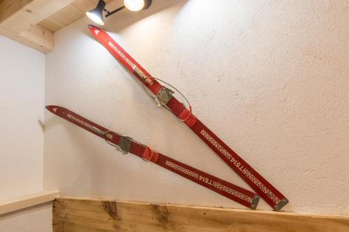 two baseball bats are hanging on a wall at Der kleine Stadl in Oberried
