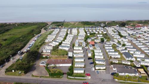 an aerial view of a parking lot with white houses at Beachside Holiday Park in Brean