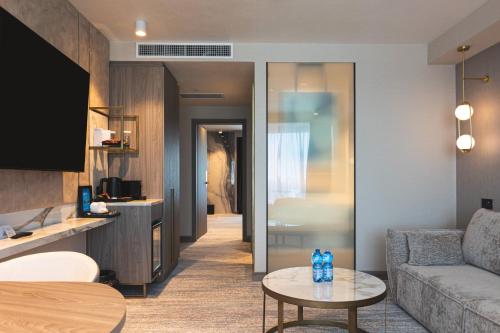 a living room with a couch and a table at Crowne Plaza Constanta - Mamaia Beach by IHG in Mamaia