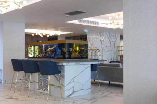 a bar with a fish tank on top of it at Crowne Plaza Constanta - Mamaia Beach by IHG in Mamaia