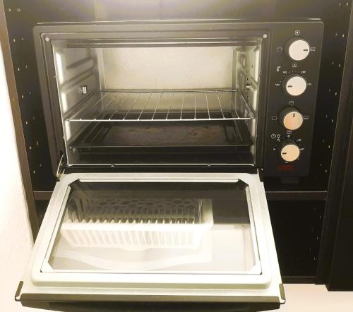 a toaster oven with its door open with the door open at H&M Homes Apartments in Aarhus