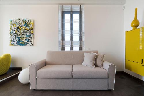 a living room with a couch and a painting at Torre dei 7 Frati in Cefalù