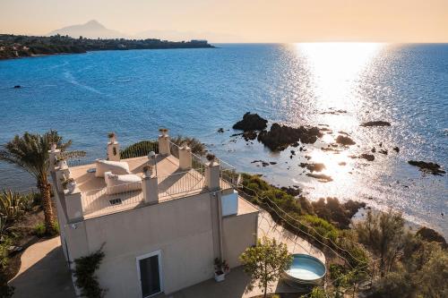 an aerial view of a house and the ocean at Torre dei 7 Frati in Cefalù