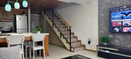 a kitchen with a staircase leading to a living room at Chaoyang Joy City Hardcover Apartment in Beijing