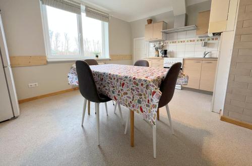 een tafel in een keuken met een tafelkleed erop bij Vintage 70 Villa in Šiauliai