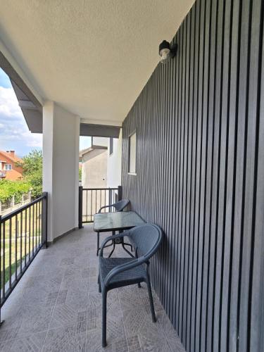 a table and a chair on a balcony at Hotel Mažijanik in Nikšić