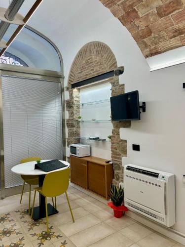 a kitchen with a table and a window and a table at THE PALACE B&B and Apartments in Santo Stefano di Camastra