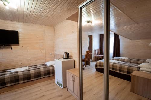 a hotel room with two beds and a television at Hotel Duet in Maydan