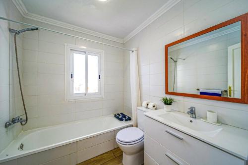 łazienka z wanną, toaletą i umywalką w obiekcie Villa Magali Mar by Villa Plus w Corralejo