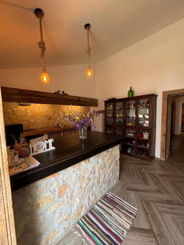 a kitchen with a counter with a stone wall at Casa das Flores - no Parque Natural Guadiana in Mértola