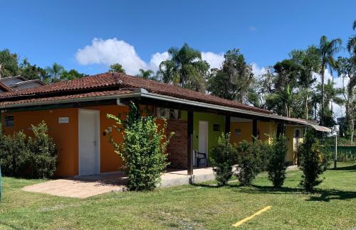 a small house with bushes in front of it at Refúgio do Bosque in Penha