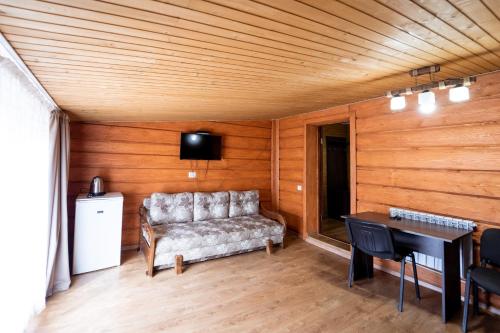 a living room with a couch and a table at Hotel Duet in Maydan