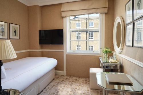 a hotel room with a bed and a window at The Montague On The Gardens in London
