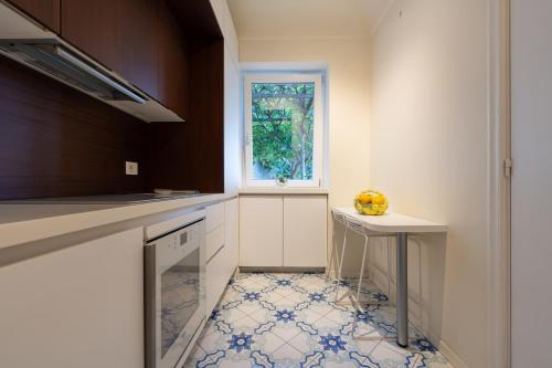 a kitchen with a table and a window at La Gioiella Capri in Capri