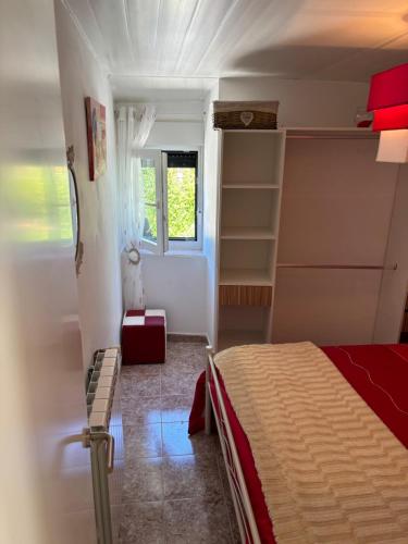 a bedroom with a bed and a window at Carballo Alenza,2 in Castro Caldelas