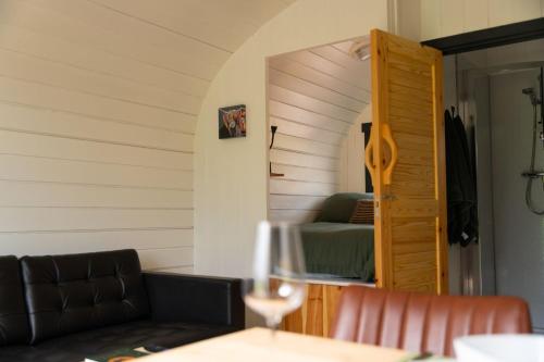 a living room with a couch and a bed in a room at Ben Nevis Pod in Fort William