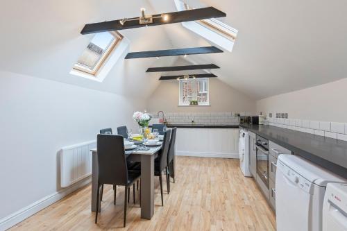 a kitchen and dining room with a table and chairs at Redhill Hideaway Stylish Spacious Apartment in Redhill