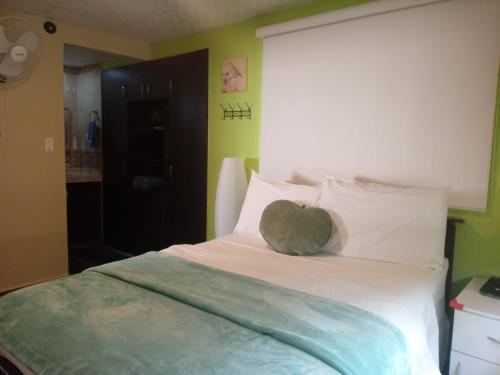 a bed with a heart pillow on top of it at Casita Independiente, Ubicada Atrás de Nuestra Casa in David