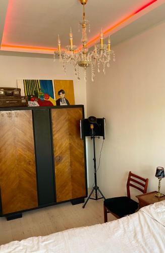 a room with a bed and a chandelier at Rigas Street LUX Apartment in Daugavpils