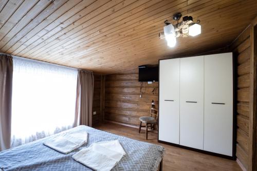 a bedroom with a bed and a large window at Hotel Duet in Maydan