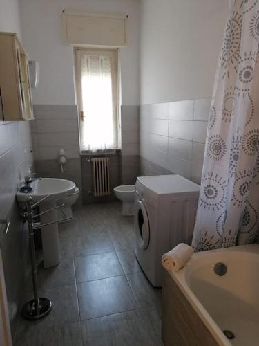 a bathroom with a sink and a toilet and a tub at Flavia House in Ladispoli