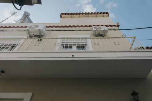a white building with windows on top of it at Pappous Adreas in Skiathos Town