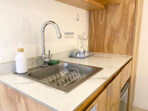 a kitchen counter with a sink in a kitchen at Studios Downtown Cancun in Cancún