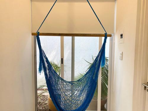 a blue hammock hanging from a window in a room at Studios Downtown Cancun in Cancún