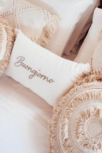 a piece of paper with the word forgiveness on a bed at Villa Giulia Relais & Spa in Jesolo