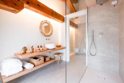 a bathroom with a shower and a glass shower stall at Villa Giulia Relais & Spa in Jesolo