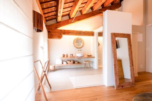 an open living room with a wooden ceiling at Villa Giulia Relais & Spa in Jesolo