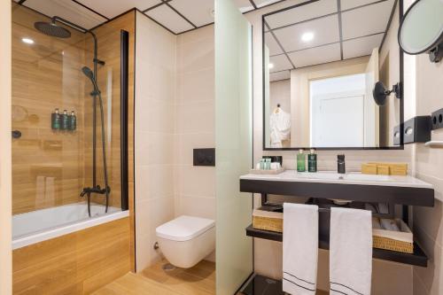 a bathroom with a sink and a shower and a toilet at Melia Alicante in Alicante