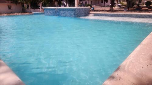 a large pool of blue water in a yard at Sea Shell Palms, Ocho Rios in Ocho Rios