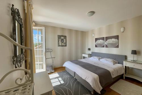 a bedroom with a large bed and a window at La Terrasse in Douzillac