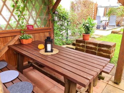 a wooden picnic table with a candle on it at Ruhige Ferienwohnung in Bad Tölz in Bad Tölz