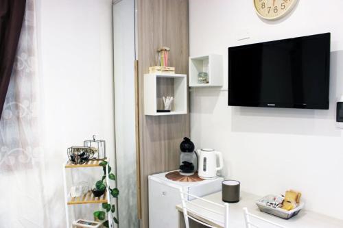 a living room with a flat screen tv on a wall at Beb Cuore del Salento in Merine