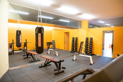 a gym with two boxing bags hanging from the ceiling at Apartamentos do Lago in Ferreira do Zêzere