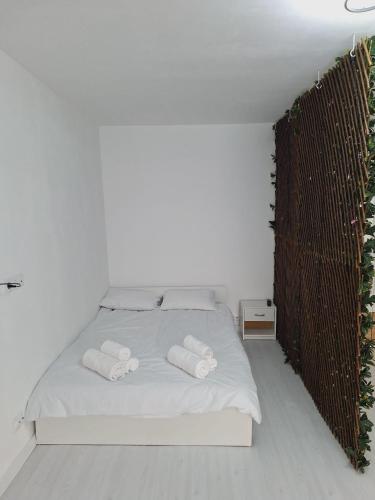 a bedroom with a bed with two towels on it at R&R studio in Cluj-Napoca