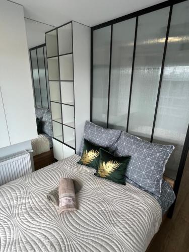 a bedroom with a large bed with two pillows at Apartament Zielona Klonowa in Kielce