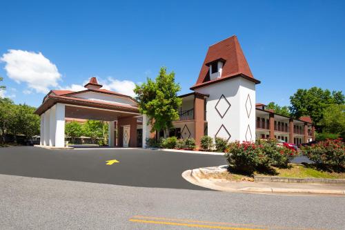 a small building with a clock tower on a street at Days Inn by Wyndham Helen in Helen