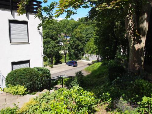 a car driving down a street next to a house at Apartment Harzgrün 1 in Sankt Andreasberg