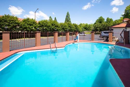 a large blue swimming pool with a fence at Days Inn by Wyndham Helen in Helen